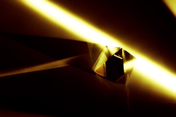 Glass pyramid in abstract yellow light