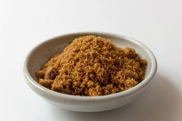 Dark brown sugar on a white background