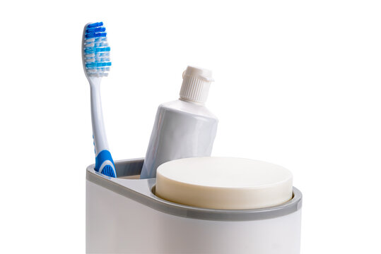 Single New Blue Handle Toothbrush And A Tube Of Toothpaste In Plastic Holder Isolated On White Background With Clipping Path.