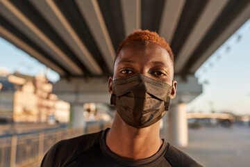 Portrait of young black man wearing medical mask