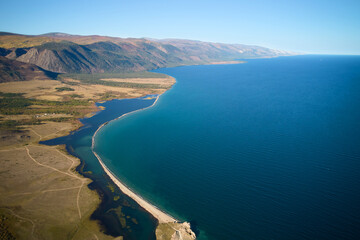 Fototapeta na wymiar Lake Baikal from the air. View of the bay, mountains.