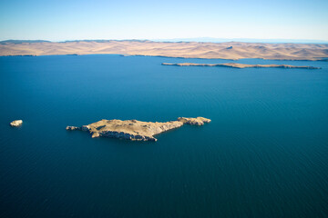 Fototapeta na wymiar Lake Baikal from the air on a summer day. View of the islands of Ogoy, Oltrek and Olkhon.