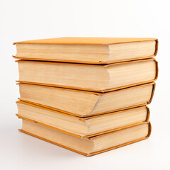 Stack of old books on light background. Book pile.