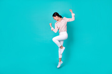 Fototapeta na wymiar Full body photo of young japanese woman raise fists achieve goal dressed trendy smart casual outfit isolated on aquamarine color background
