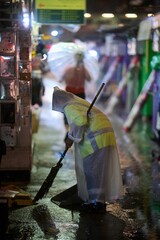 Vertical of a road sweeper working on a rainy night in Mong Kok, Hong Kong.