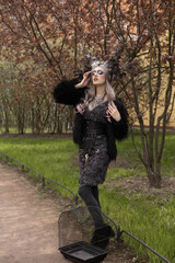 Witch with a crown of feathers. girl in an unusual figure

