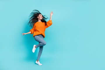 Fototapeta na wymiar Full length portrait of pretty positive person enjoy free time dance look empty space isolated on teal color background