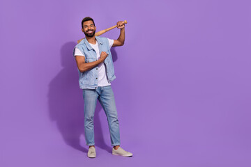 Full length photo of cool strong guy dressed denim vest holding batter showing muscle empty space isolated purple color background