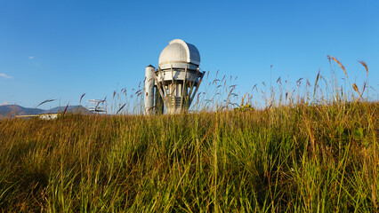 Large buildings of the observatory in the form of a dome. The telescopes are closed. Beautiful tall...