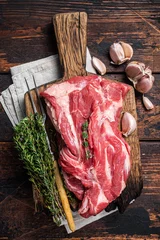 Fotobehang Raw Boneless lamb meat, raw neck meat on wooden board. Black background. Top view © Vladimir
