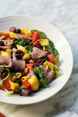 Antipasto salad with fresh meat, cheese and vegetables