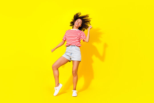 Full size photo of brunette cool lady dance wear t-shirt shorts shoes isolated on bright yellow color background