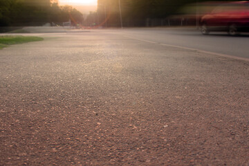 Road at sunset. Street illuminated by the sun.
