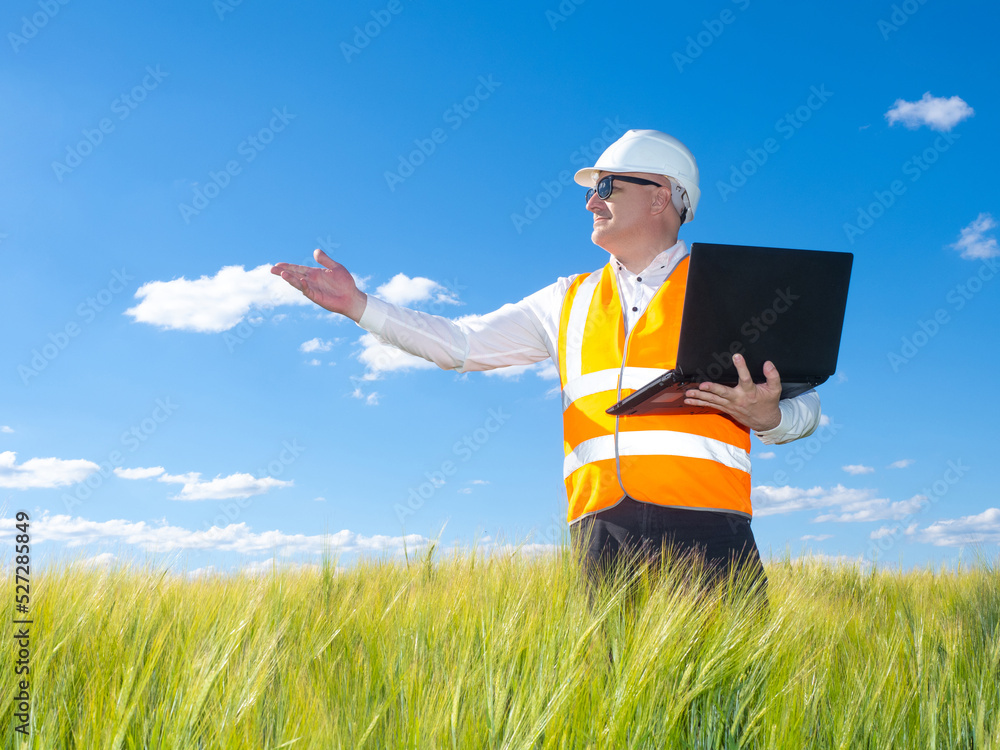 Poster builder developer. man with laptop stands in grass. builder developer in worker uniform. builder ins