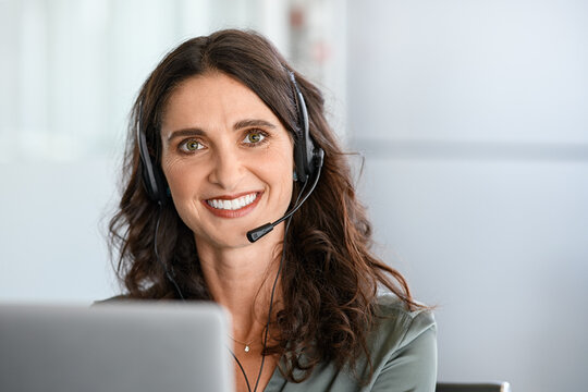 Mature happy woman working on phone call