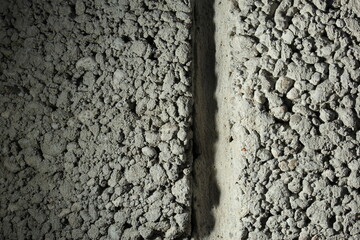 close up of a gray foam concrete building block. grey textured background