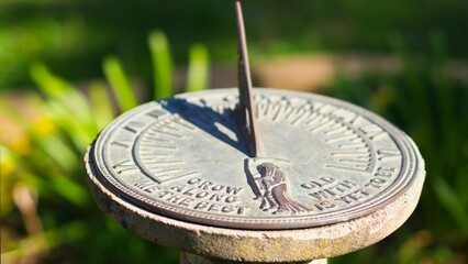 Closeup shot of a traditional sundial timekeeping device - obrazy, fototapety, plakaty