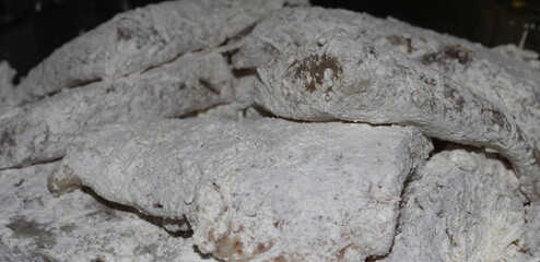 fish fillet with flour for breading, breaded fish ready to fry, raw fish for frying