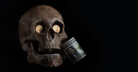 Model of a human skull and a pack of American dollars