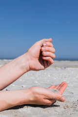 Hand playing with sand