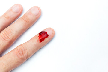 The man cut his finger and is bleeding. Accident. Top view. Place for text. Copy space.