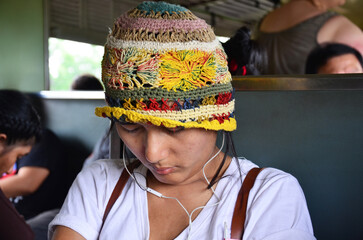 Asian thai women travelers people sit listen music and sleep dream on locomotive train after travel...