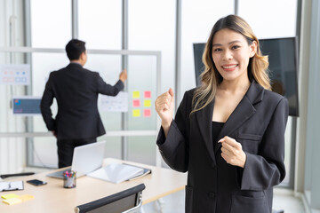 Asian businesswomen looking at the camera Working and meeting at the office at the company with colleagues at the back