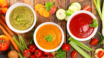 assorted of bowl of soup ( zucchini,  tomato and pumpkin or carrot)