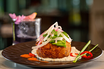 Crab Cake over Green Onion Puree, topped with Fennel Slaw and Red Peppers