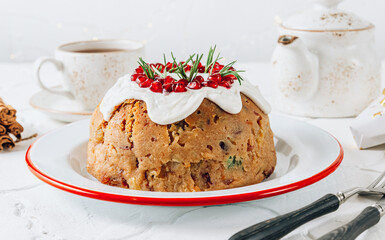 Fototapeta na wymiar Traditional Christmas fruit pudding on white festive background.