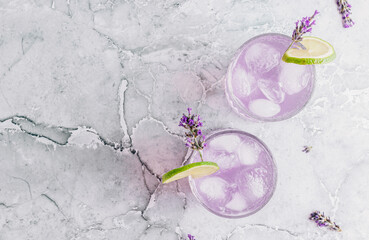 Lemonade with lime and lavender on gray marble background