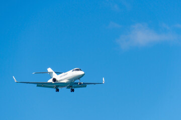 Blurred business jet in clear blue sky. Private jet in flight.