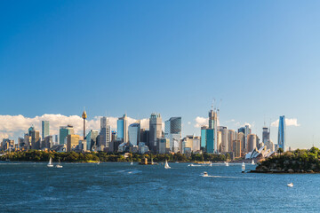Obraz premium Beautiful panorama of Sydney city skyline viewed across the harbour from the Taronga Zoo Wharf on a bright day
