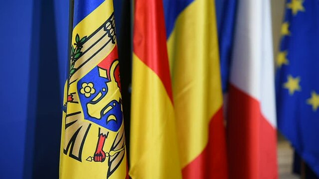 Moldavian flag next to german, romanian, french and the European Union flags during a political summit
