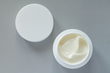 Container of beauty treatment cream with cap background