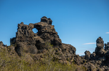 Fototapeta na wymiar Dimmuborgir Exposure or the Black Fortress, is a dramatic expanse of lava in the Lake Mývatn area. Steeped with folklore, it is one of the most popular destinations for travellers to north Iceland.