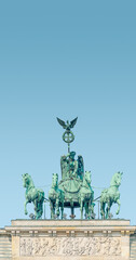 Cover page with Quadriga, four horses lead by Viktoria, Roman goddess of victory at Brandenburg Gate in Berlin historical downtown, Germany, at summer day, blue sky background and copy space.