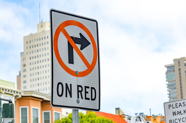 A street sign in San Francisco, California telling drivers that a right turn on a red light is not...
