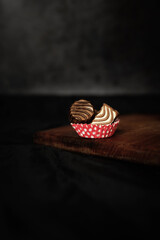 Chocolate bars on a wooden board and on a dark background. Dark style. Minimal food concept. Creative idea.