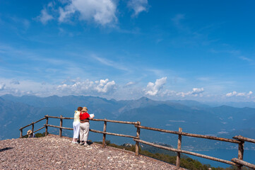 Tourists on the top of Monte Mottarone near Stresa look out over Lake Maggiore