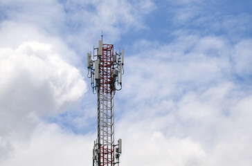 Telecommunication tower of 4G and 5G cellular. Macro Base Station. 5G radio network telecommunication equipment with radio modules and smart antennas mounted on a metal against cloulds sky background