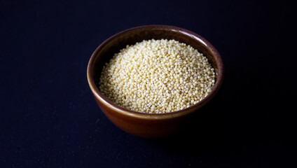 uncooked millet in a bowl
