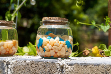 A glass jar with colored stones