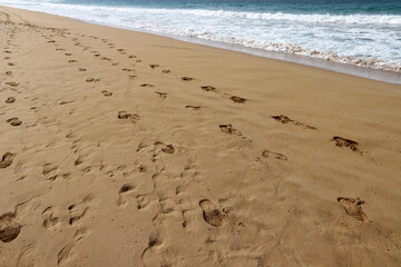Footprints in the sand on the shores of the Mediterranean Sea.