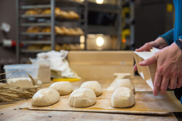 Baker carrying a tray of freshly baked bread