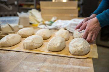Baker carrying a tray of freshly baked bread
