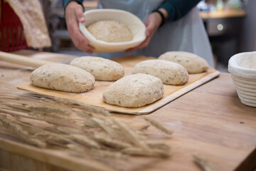 Baker carrying a tray of freshly baked bread