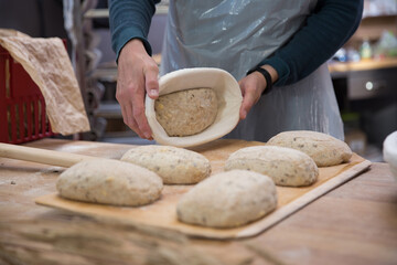 Baker carrying a tray of freshly baked bread