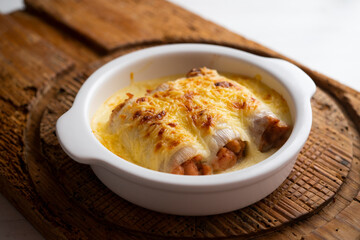 Meat cannelloni with bechamel sauce and gratin cheese. Traditional Spanish Christmas Tapa.