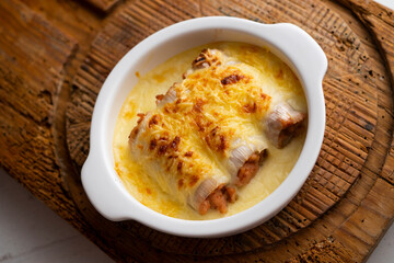 Meat cannelloni with bechamel sauce and gratin cheese. Traditional Spanish Christmas Tapa.